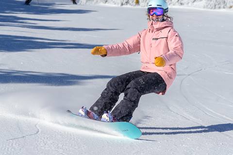 Female snowboarder on empty trail at Stratton Mountain Resort 