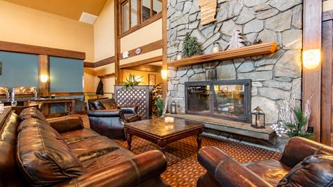Interior view of the hearth and fireplace at the black bear lodge a ski lodge at stratton mountain lodge