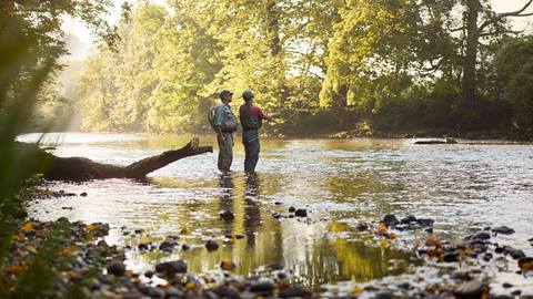 Two adults fly fishing on the Battenkill River