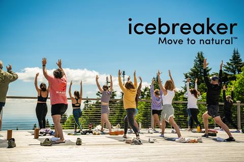 people doing yoga on the summit of stratton wooden yoga deck