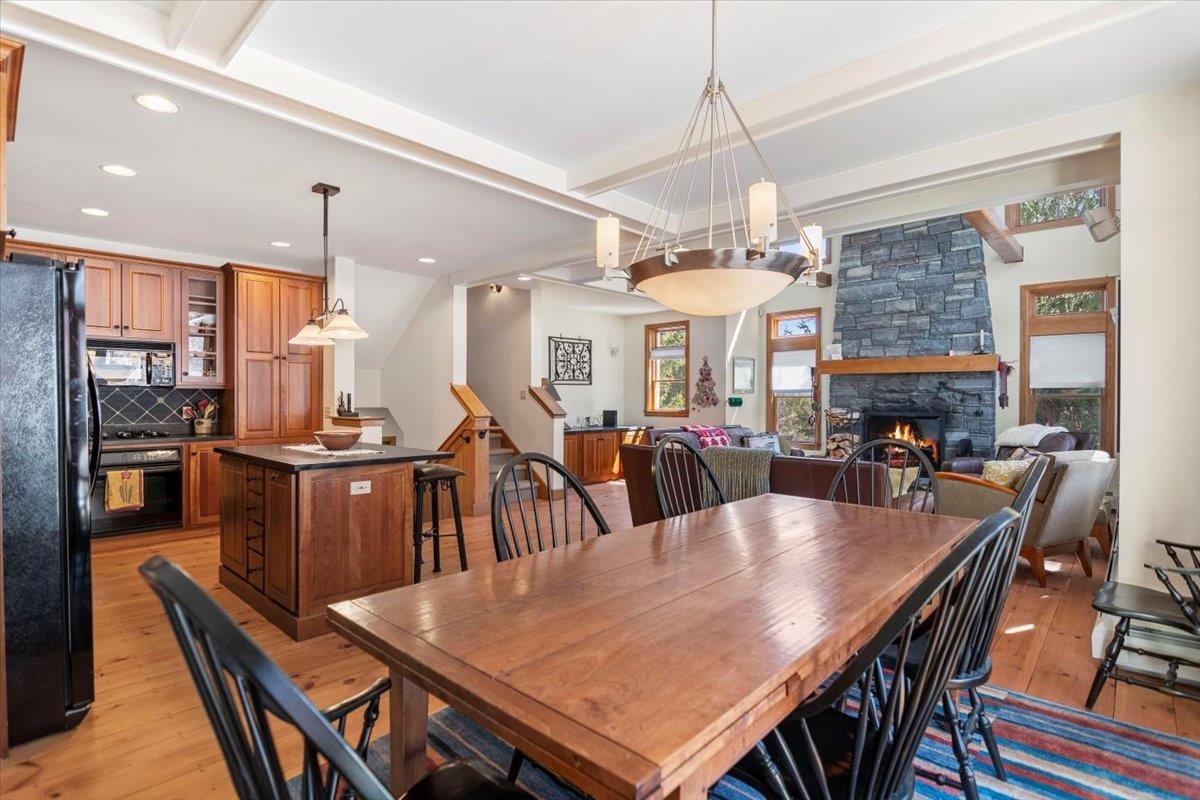 Spacious open concept kitchen, dining, and living area at 63A Sun Bowl Ridge Road, ideal for Vermont real estate buyers seeking Stratton real estate listings with cozy fireplaces and mountain-style interiors