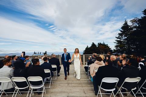Walking down the aisle at the Summit Wedding at the Stratton Mountain Hubert Haus